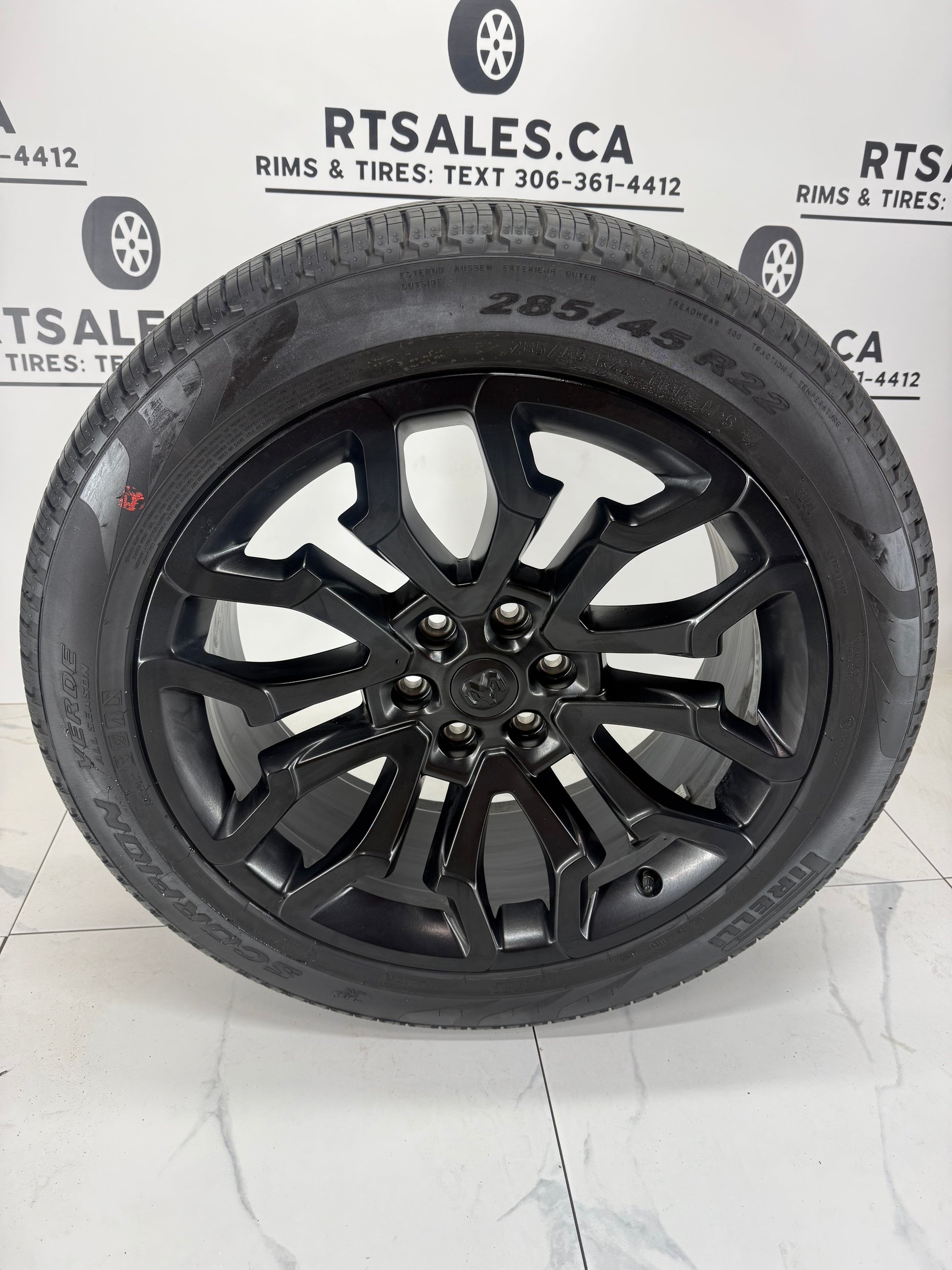 285/45R22 Pirelli Scorpion Verde all season tire on a black 22x9 Ram 1500 factory OEM rim, face view